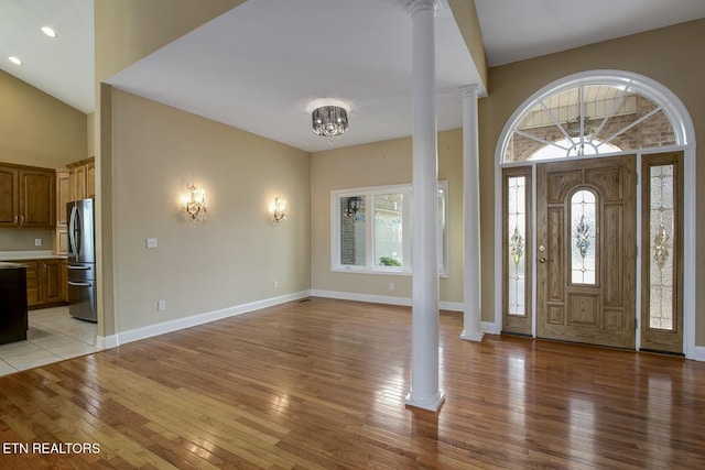 304 Coweta Ct, Loudon, TN 37774 - foyer entrance with ornate columns, an inviting chandelier, light wood-type flooring, baseboards, and a towering ceiling
