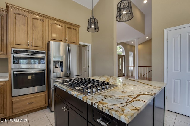 304 Coweta Ct, Loudon, TN 37774 - kitchen featuring light tile patterned floors, a kitchen island, appliances with stainless steel finishes, and light countertops