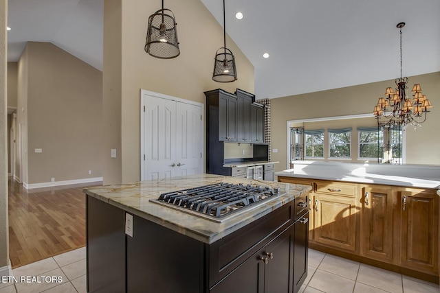 304 Coweta Ct, Loudon, TN 37774 - kitchen featuring stainless steel gas stovetop, a chandelier, light tile patterned floors, high vaulted ceiling, and a kitchen island