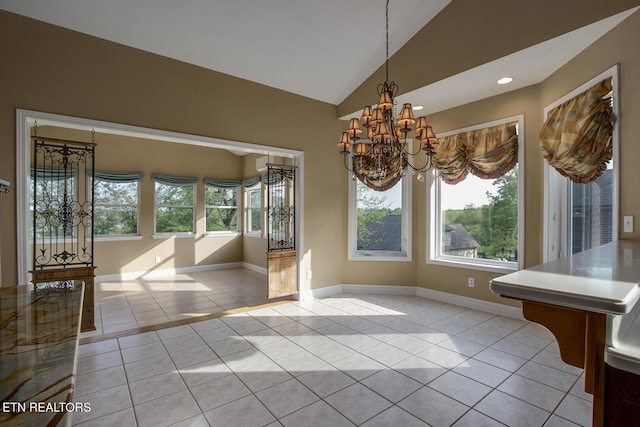 304 Coweta Ct, Loudon, TN 37774 - unfurnished dining area featuring light tile patterned floors, an inviting chandelier, vaulted ceiling, and plenty of natural light