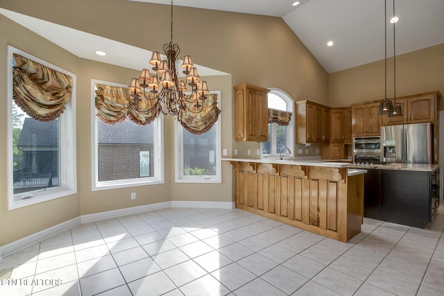 304 Coweta Ct, Loudon, TN 37774 - kitchen with a sink, stainless steel fridge, a notable chandelier, a breakfast bar, and a peninsula