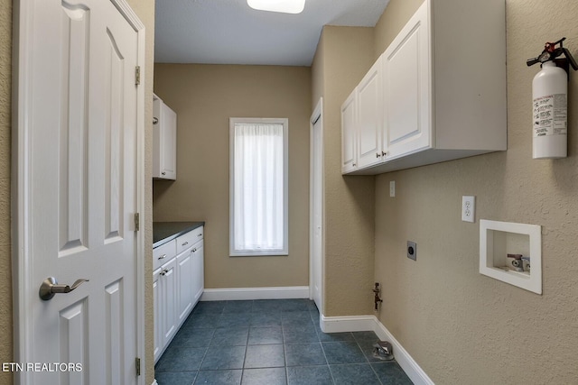 304 Coweta Ct, Loudon, TN 37774 - clothes washing area with dark tile patterned floors, cabinet space, hookup for an electric dryer, washer hookup, and baseboards