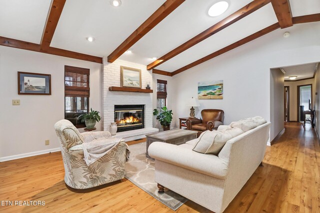 13 Oxford Cir, Fairfield Glade, TN 38558 - living room featuring baseboards, light wood finished floors, lofted ceiling with beams, and a fireplace