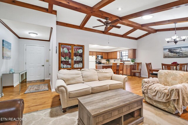 13 Oxford Cir, Fairfield Glade, TN 38558 - living area featuring light wood-style flooring, lofted ceiling with beams, ceiling fan with notable chandelier, and baseboards