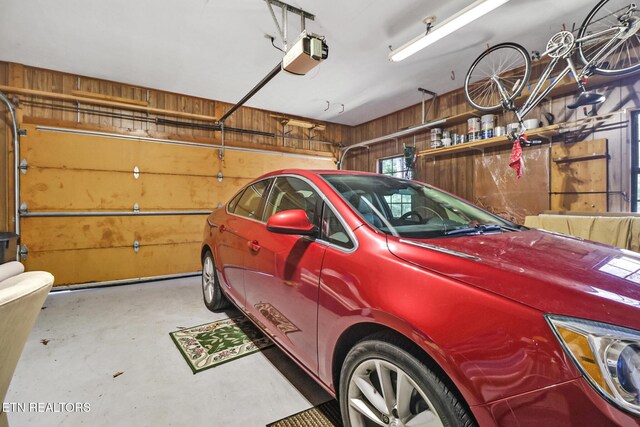 13 Oxford Cir, Fairfield Glade, TN 38558 - garage with a garage door opener and wood walls