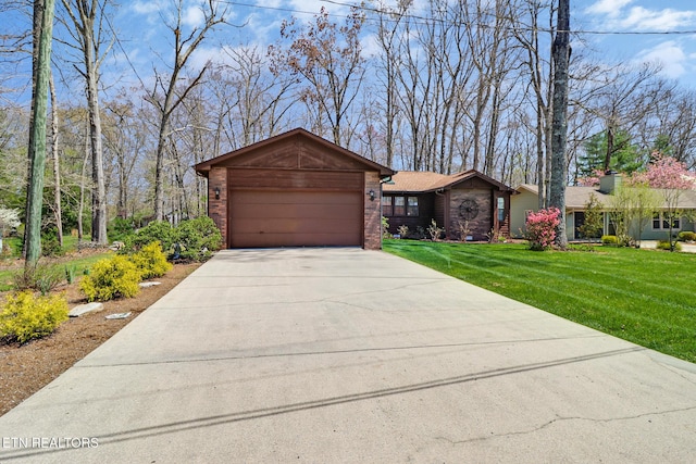 13 Oxford Cir, Fairfield Glade, TN 38558 - ranch-style home with concrete driveway, an attached garage, brick siding, and a front lawn
