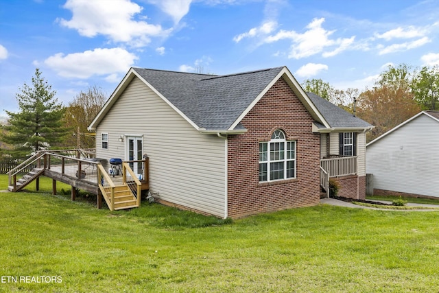 4716 Cabbage Ln, Knoxville, TN 37938 - back of house with a shingled roof, a deck, and a lawn