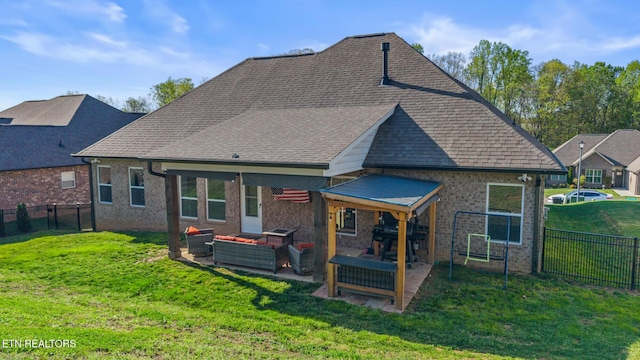 back of property featuring a fenced backyard, an outdoor living space, and a lawn