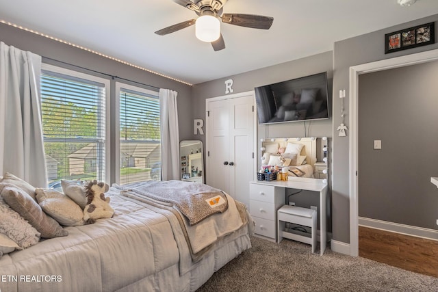 bedroom featuring a closet, baseboards, a ceiling fan, and carpet floors