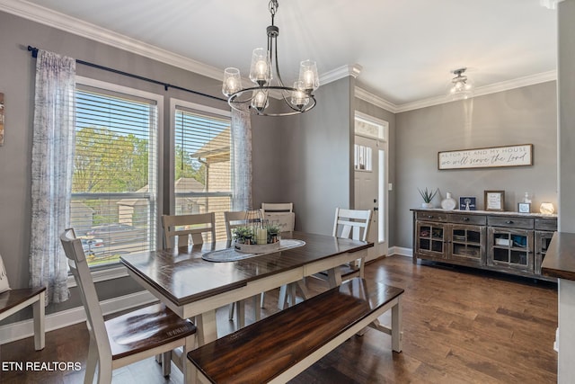 dining room with crown molding, baseboards, a chandelier, and wood finished floors