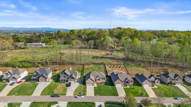 birds eye view of property with a view of trees and a residential view