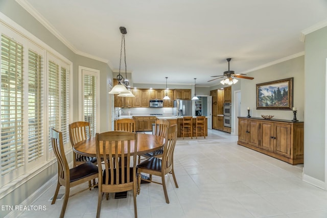 dining area featuring crown molding, light tile patterned flooring, baseboards, and a ceiling fan
