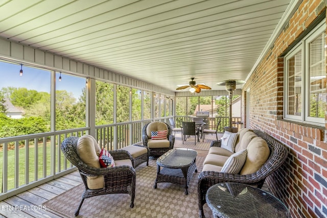 sunroom / solarium with an outdoor hangout area, a ceiling fan, and plenty of natural light