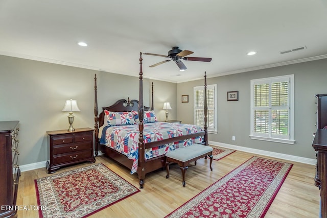 bedroom featuring crown molding, baseboards, and light wood-style flooring