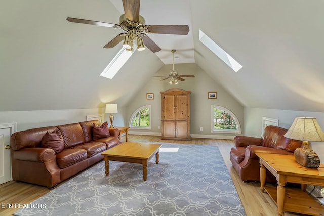 living room featuring wood finished floors, ceiling fan, and a wealth of natural light