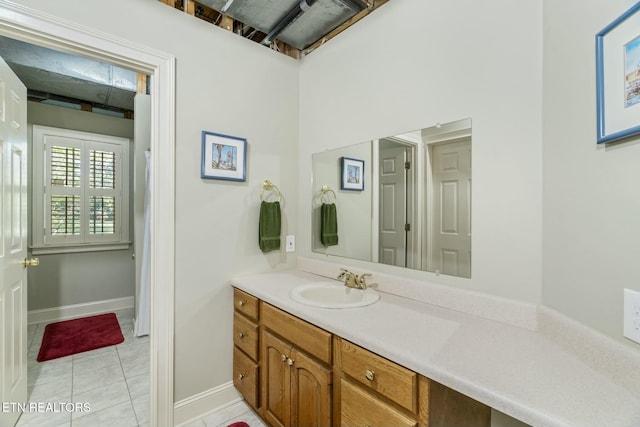 bathroom with tile patterned floors, vanity, and baseboards