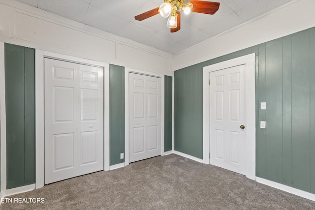 2214 Lincoln St, Knoxville, TN 37920 - unfurnished bedroom featuring two closets, a ceiling fan, and carpet