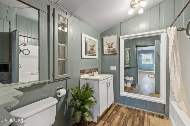 2214 Lincoln St, Knoxville, TN 37920 - bathroom with a shower with shower curtain, toilet, vanity, wood finished floors, and vaulted ceiling