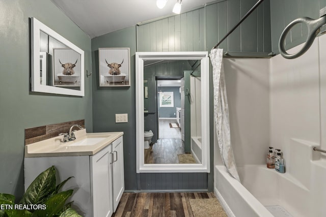2214 Lincoln St, Knoxville, TN 37920 - bathroom with vanity, shower / tub combo with curtain, toilet, lofted ceiling, and wood finished floors