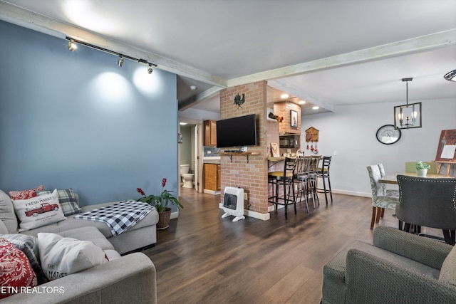 2214 Lincoln St, Knoxville, TN 37920 - living area featuring track lighting, heating unit, a chandelier, dark wood finished floors, and beamed ceiling