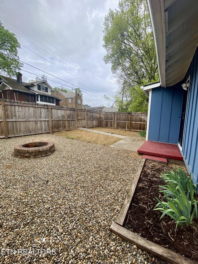 view of yard featuring an outdoor fire pit and a fenced backyard