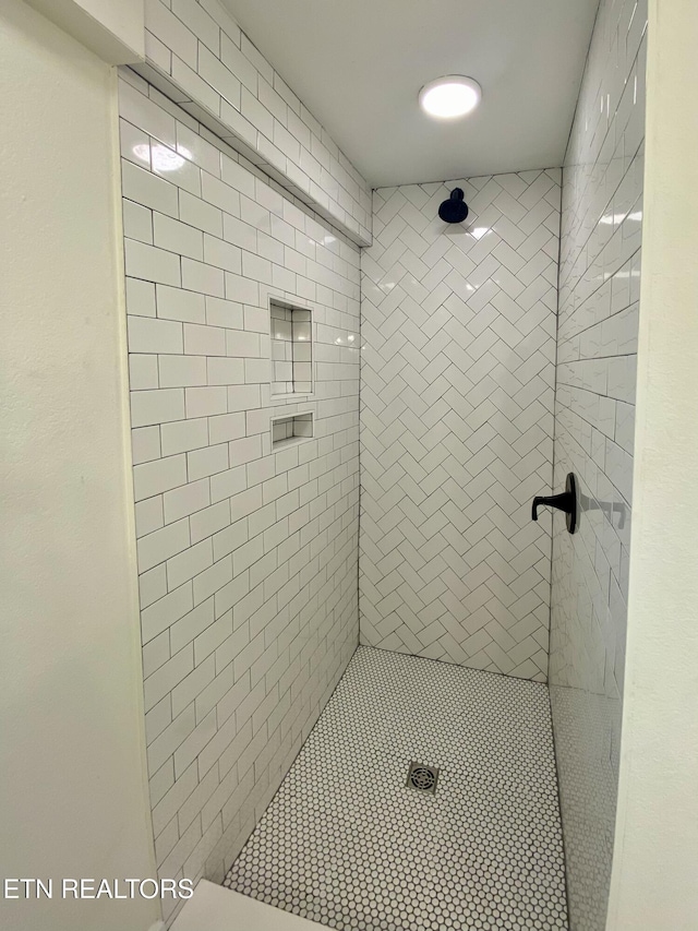 bathroom with a tile shower