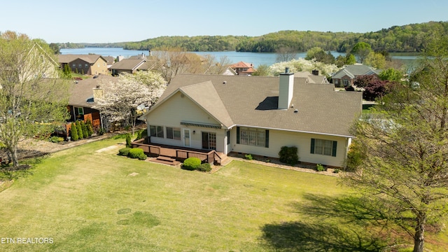 drone / aerial view with a water view and a forest view
