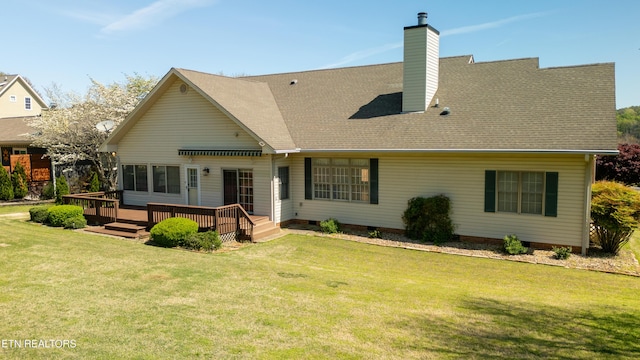 back of house featuring crawl space, a yard, a chimney, a shingled roof, and a deck