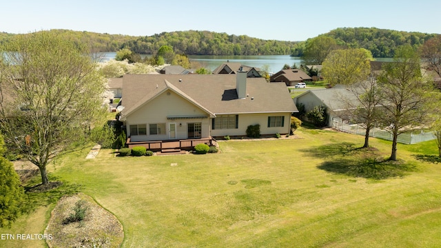 birds eye view of property featuring a water view and a view of trees