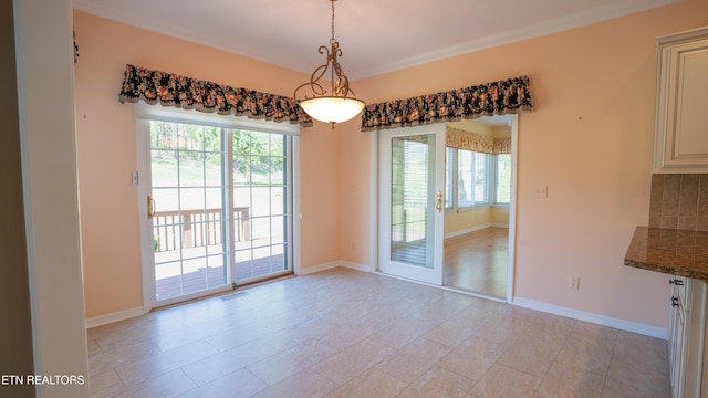unfurnished dining area with visible vents, baseboards, and ornamental molding