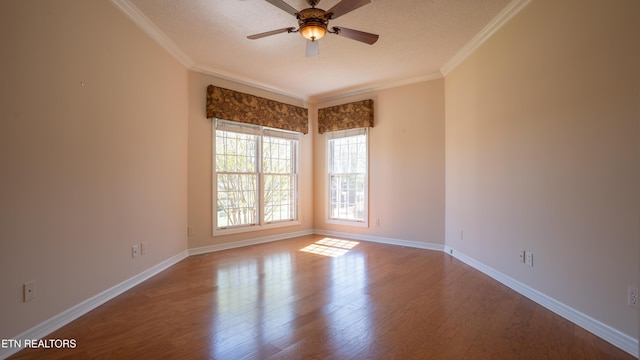 unfurnished room with crown molding, a textured ceiling, a ceiling fan, wood finished floors, and baseboards