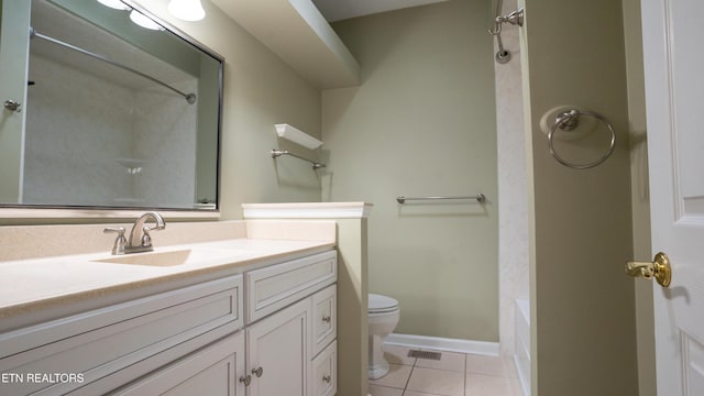 bathroom with vanity, baseboards, tile patterned flooring, toilet, and visible vents