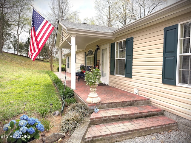 entrance to property featuring a yard