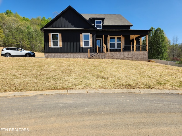 180 W Park Cir, Decatur, TN 37322 - view of front facade with board and batten siding, a front lawn, and covered porch