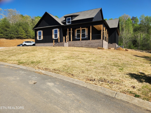 180 W Park Cir, Decatur, TN 37322 - view of front of property featuring a porch, roof with shingles, board and batten siding, and a front lawn
