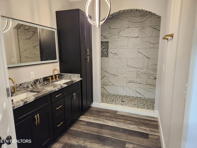 180 W Park Cir, Decatur, TN 37322 - bathroom with tiled shower, double vanity, a sink, and wood finished floors