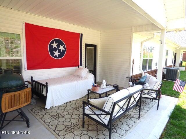 bedroom with wooden ceiling and concrete flooring