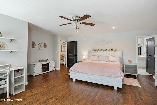 bedroom featuring ceiling fan, ensuite bath, wood finished floors, and baseboards