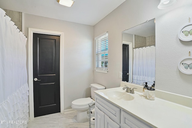 full bathroom featuring curtained shower, vanity, marble finish floor, and toilet