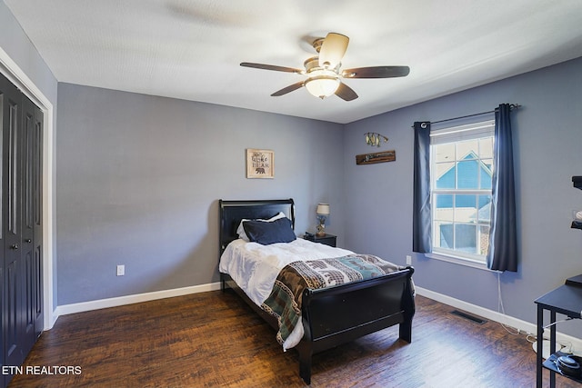 bedroom with visible vents, baseboards, a ceiling fan, and wood finished floors