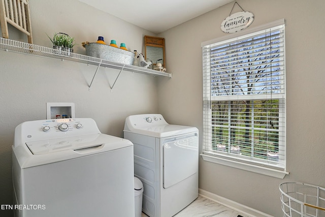laundry room with washer and clothes dryer, marble finish floor, laundry area, and baseboards