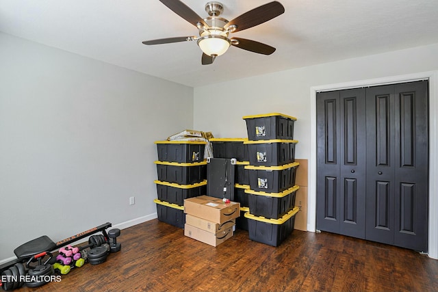interior space with a closet, baseboards, ceiling fan, and wood finished floors
