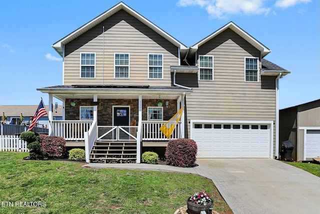 traditional-style house featuring concrete driveway, a front lawn, a porch, a garage, and fence