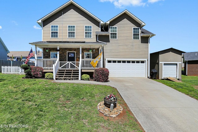 traditional-style home featuring concrete driveway, a front yard, a porch, and an attached garage