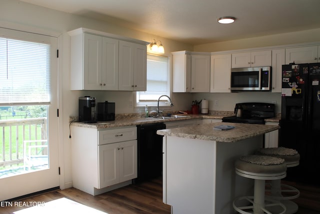 1016 W W Hill Rd, Jamestown, TN 38556 - kitchen featuring a center island, a sink, black appliances, white cabinetry, and wood finished floors