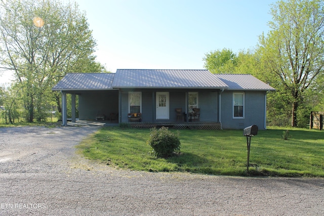 1016 W W Hill Rd, Jamestown, TN 38556 - single story home featuring a porch, metal roof, a front lawn, driveway, and an attached carport