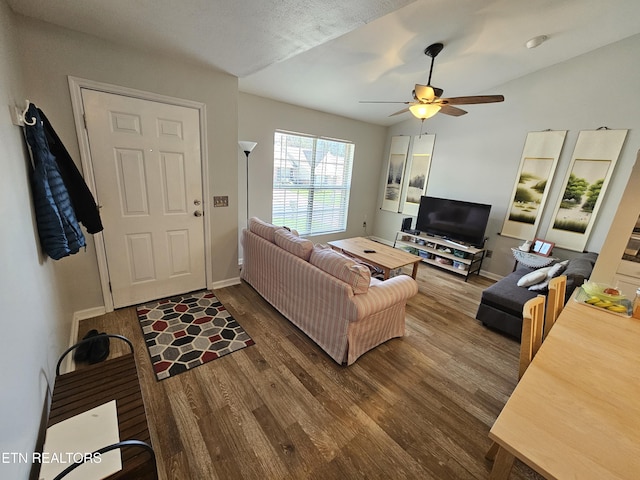 living area with wood finished floors, ceiling fan, and baseboards