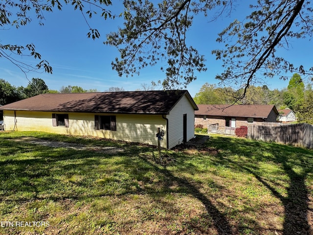 exterior space featuring fence and a lawn