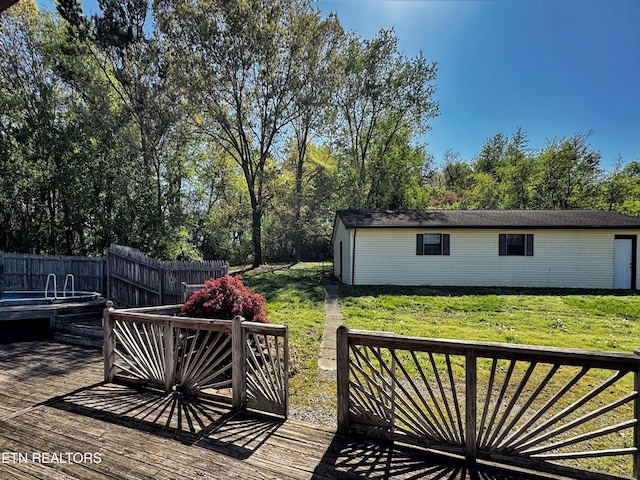wooden terrace featuring fence and a lawn