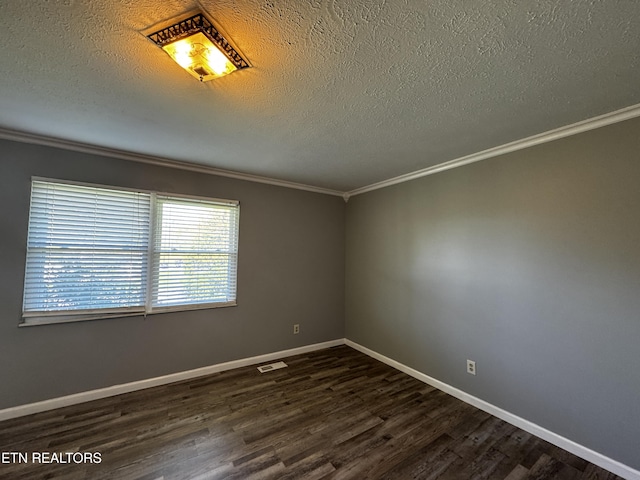 spare room with baseboards, a textured ceiling, crown molding, visible vents, and dark wood finished floors